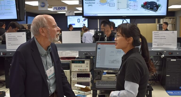 Two researchers examine equipment